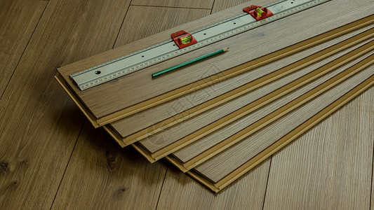 使用铅笔和仪表的橡木层地板工作抛光建筑木工改造控制板材料安装镶板家居层压背景图片