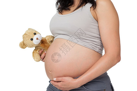 孕妇触摸着她的撞伤 抱着泰迪背景图片