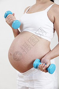 手重近距离接近孕妇的体重锻炼背景