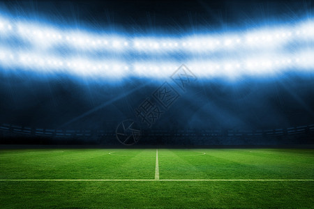 蓝灯下足球球场背景图片