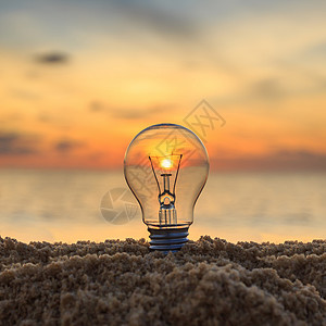 上关花日落海滩上关灯泡 能源概念背景