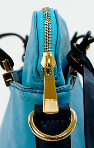 拉链接缝皮革女性蓝色配饰戒指手提包商业金属背景图片