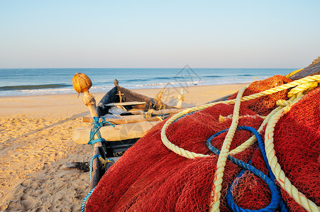 鱼腥味的红渔网海滩漂浮海浪绳索沿海渔业情调海洋海湾软木背景