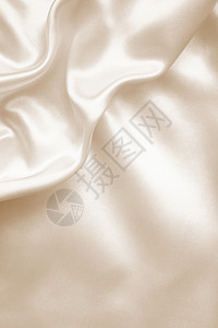 塞翁优雅的金丝绸作为婚礼背景 在塞皮亚纺织品材料折痕调子棕褐色版税窗帘布料新娘投标背景