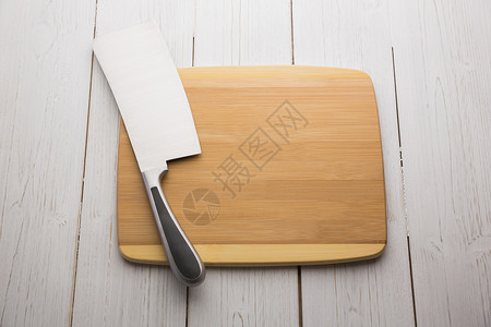 拿着大刀的购物板美食烹饪用具切菜板厨艺木板屠夫阴影背景图片