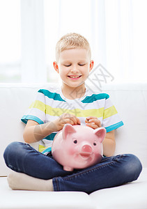 坐着微笑猪家里有猪银行的笑笑小男孩财富幸福学生快乐奖金银行业教练小猪储蓄童年背景