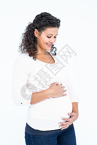 快乐的孕妇触摸腹部背景图片