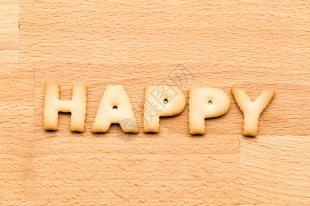 醒着拼字体在木木背景上说着快乐的曲奇背景