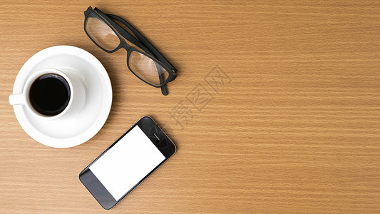 咖啡杯 电话和眼镜办公室商业创造力植物手机桌子咖啡杯子工作背景图片