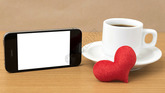 咖啡杯 电话和心脏桌子白色咖啡红色杯子手机办公室背景图片