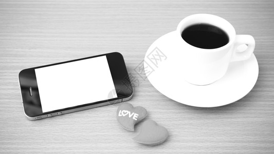 咖啡杯 电话和心脏桌子白色手机咖啡杯子办公室红色背景图片