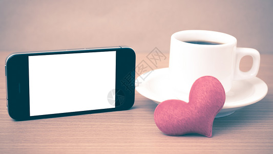 咖啡杯 电话和心脏咖啡桌子杯子手机白色红色办公室背景图片