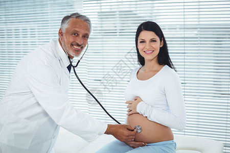 对孕妇进行检查的医生服务女士外套实验室产科医院诊所微笑家庭生活腹部背景