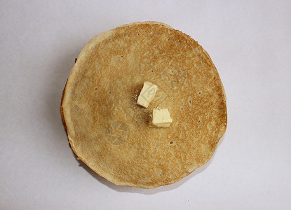 嘉年华煎饼盘子上的黄油煎饼是古代斯拉夫嘉年华庆典的象征生产率欢乐庆祝票价夫人喜庆仪式异教徒风俗木板背景
