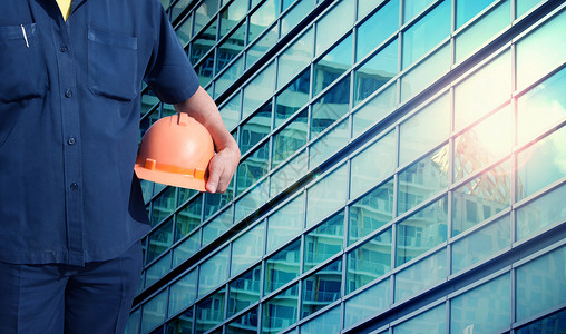 构造函数工程师为工人安全持有橙色头盔导师项目职业领带建筑师货物技术员建设者帽子建筑物背景