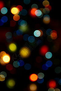 七彩圣诞树七彩散景灯蓝色魔法绿色派对庆典闪光辉光圆形黄色背景背景