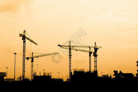 建筑建筑工人男人安全帽工作职业头盔日落团体工业劳动者住房背景图片