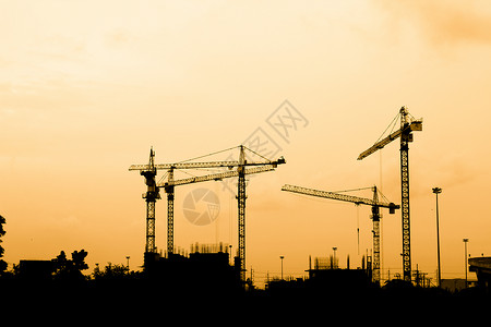 建筑建筑工人职业劳动头盔劳动者日落安全帽住房男人工业工人背景图片