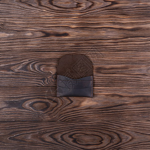 造口袋棕色手工造皮的平面照片 一个口袋持卡人 木制背景上的股票照片背景