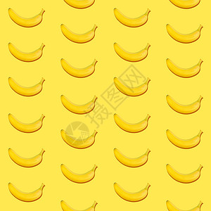 黄色背景的无缝香蕉型状水果食物季节热带背景图片