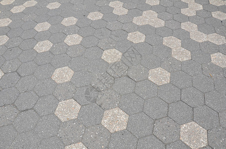 地面上的灰色六边形和黑色六边形瓷砖镶嵌背景图片