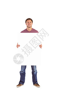 男人拿着一个标志快乐牛仔裤棕色短发男性微笑头发背景图片
