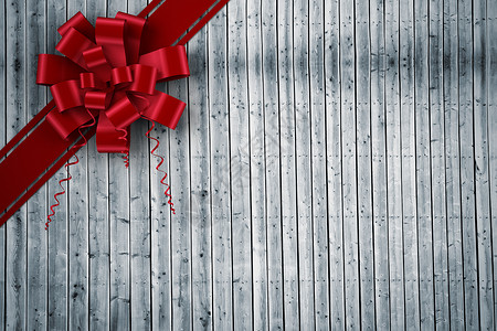红色圣诞礼章和丝带的复合图像木板时候绘图庆典假期灰色木头展示计算机礼物背景图片
