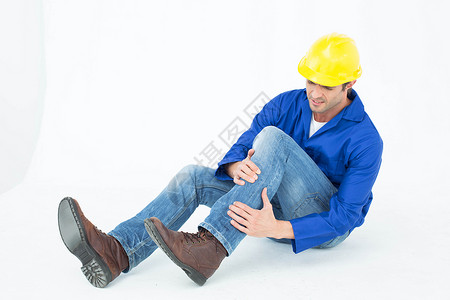 建筑师膝膝部疼痛伤害男人蓝色工人技术员安全帽工作按摩头盔身体背景