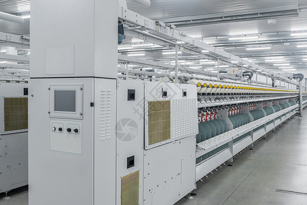 一家纺织厂的线条生产丝绸筒管设施材料自动化机器棉布白色机械技术背景图片