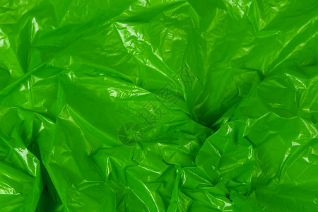 特写塑料具有选择性聚焦的皱褶绿色聚乙烯薄膜抽象背景背景
