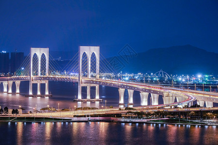 紫色桥灯水反射晚上在澳门的桥风景紫色灯柱两极灯光海洋中心货车天空建筑场景背景