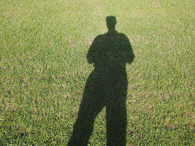绿色草地上的人影背景图片