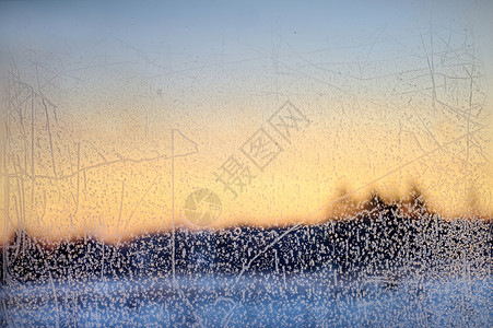太阳纹冬季玻璃上的冰纹和阳光结晶温度水晶季节蓝色日落太阳寒意寒冷微光背景