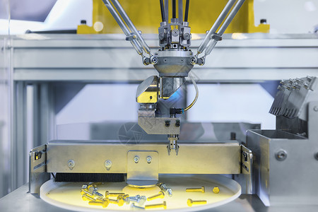 自动机器人臂在工业环境中工作 分出螺丝式螺丝坚果工程师生产机器人技术硬件机器工具机械臂拧紧背景