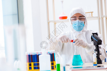 在化工实验室工作的年轻化学学青年学生危害面具显微镜卫生药品男人烧杯化学品样本技术背景