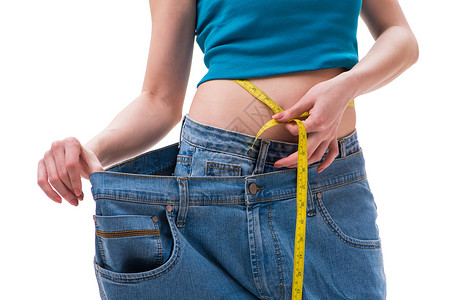 背景超大素材与超大牛仔裤一起饮食的概念重量女士腰部仪表数字躯干裤子尺寸损失磁带背景