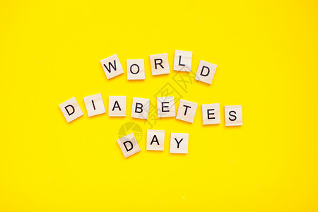 黄色背景下的世界糖尿病日的木块刻字 (笑声)背景