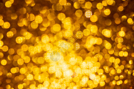 圣诞灯素材金色灯光抽象bokeh背景 基督教灯光闪耀火花彩灯庆典假期黄色圣诞色彩散景背景