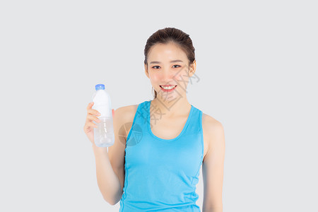 锻炼后喝白酒的运动中美丽的年轻年青女子女性数字营养女士女孩健身房饮食成人瓶子活力背景图片