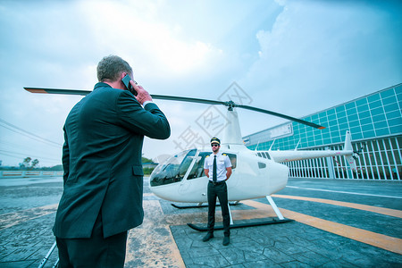 商务直升机在机场旅行的商务人士 国际机场的商务人士前往航站楼进行飞机旅行-流动性概念和航空航天业航班连接背景