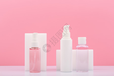 一套装有美容品的化妆瓶 在粉红色背景下定期提供皮肤护理背景图片