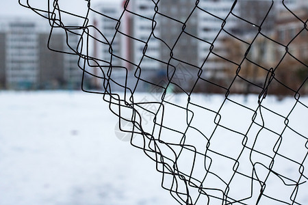 网雪高屋背景上撕裂的网状围栏背景