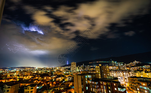 第比利斯的夜间风暴地标手电筒蓝色闪光天空背景图片
