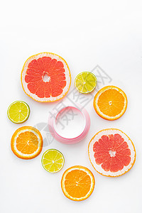 奶油和柑橘类水果 皮肤护理 冰淇淋 白种背景橙子产品洗剂塑料血清瓶子治疗面具药品皮肤科背景图片