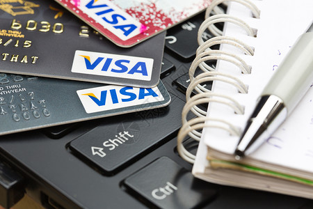8月1号2015年8月1日 信用卡VISA品牌和键盘上的钢笔社论钥匙签证金融卡片现金塑料商业取款机工作室背景