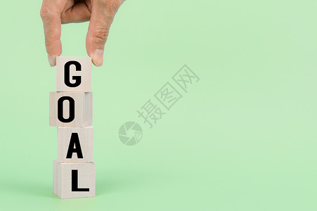 goal手持木制立方体 带有 GOAL 字样 以在企业中取得成功背景