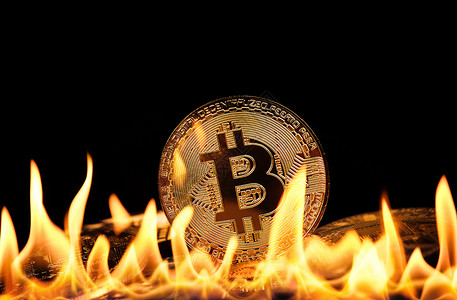 火焰中的金比特币实物硬硬币背景图片