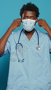 美国护士身戴面罩以防范冠状病毒的护工口罩蓝色药品医院护士黑色工作专家面具医师背景