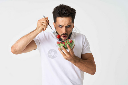 带蔬菜沙拉吃健康饮食的胡须男子板相机盘子厨房营养水平黄瓜生态男性白色绿色背景图片