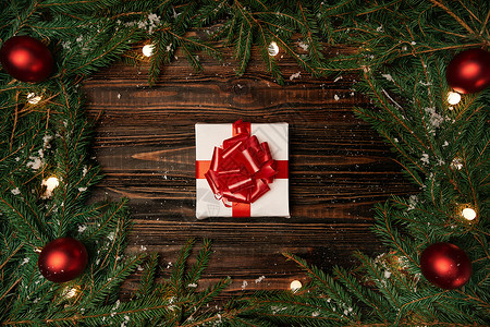 礼物盒和圣诞园地 在木质背景上庆典文化丝带假期花圈木头桌子花冠礼物传统图片